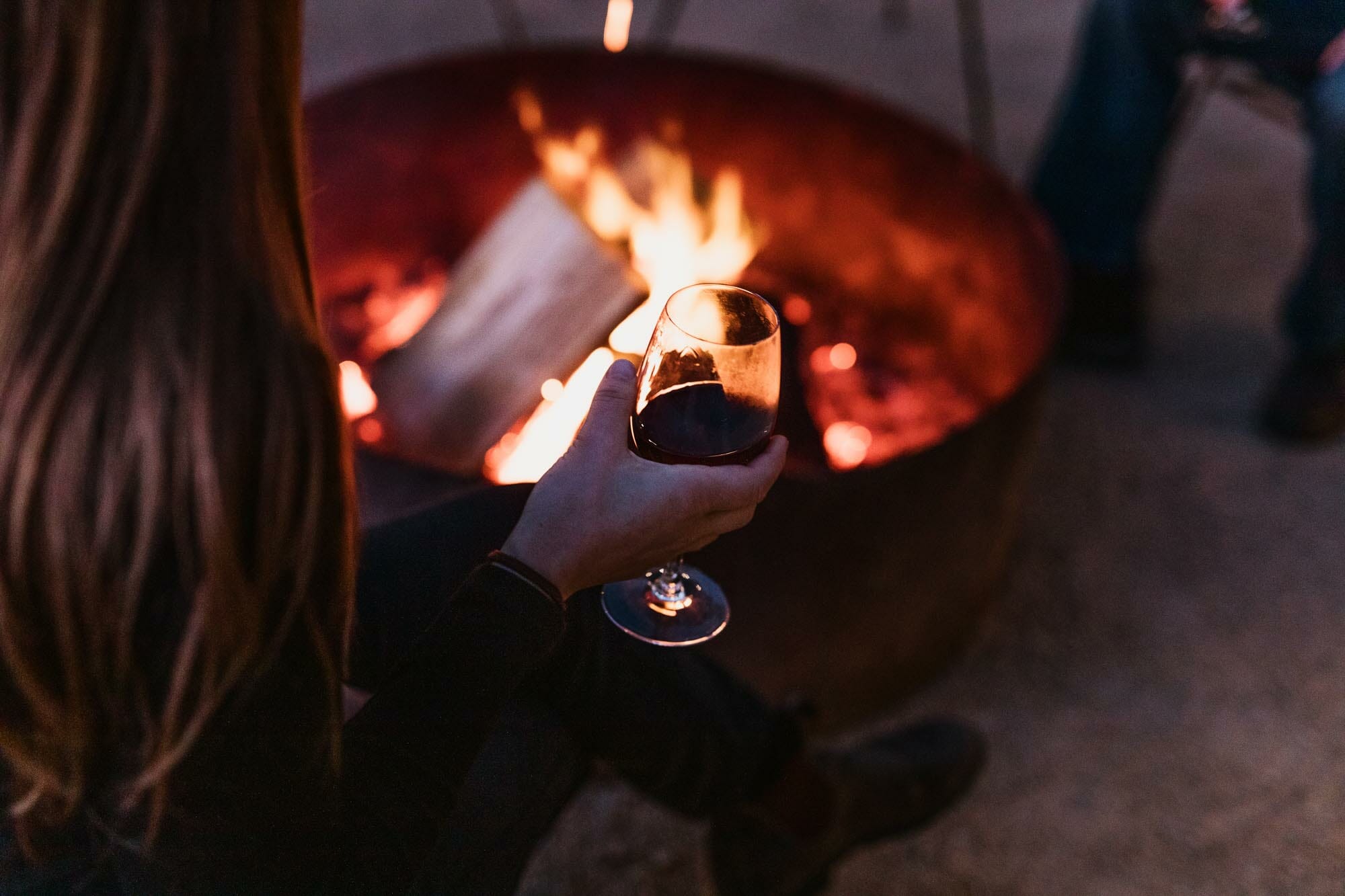 Sipping wine around the open fire